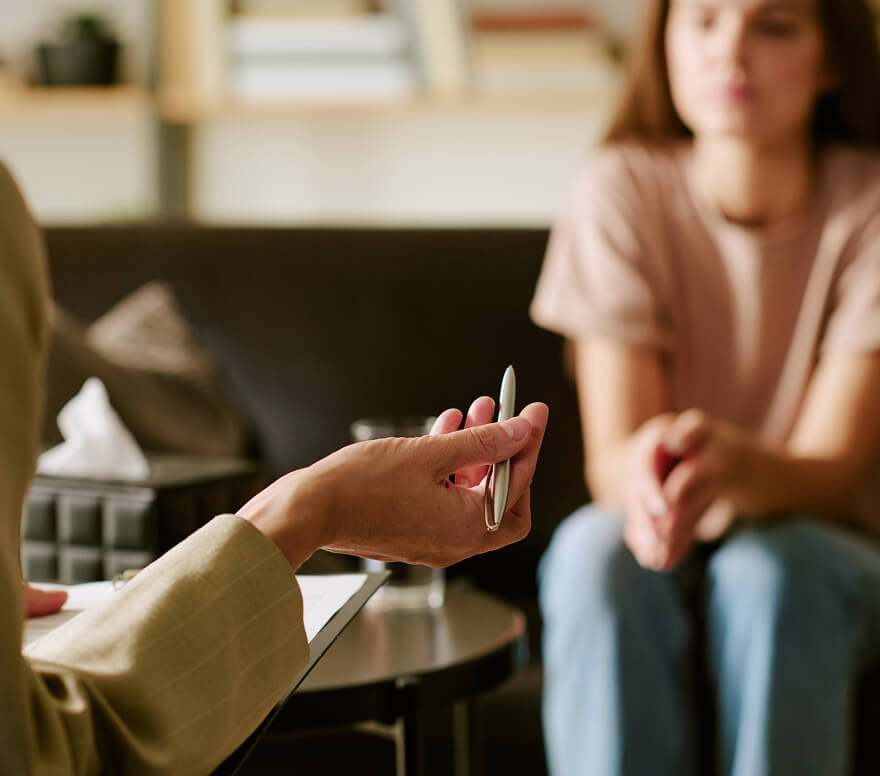 A therapist holds a pen during a one-on-one counseling session with a patient at Lighthouse Behavioral Health Solutions.
