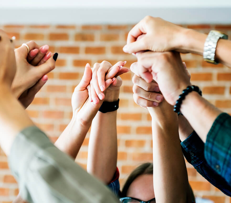 statewide-presence Group of hands joined together in a circle, showing unity.